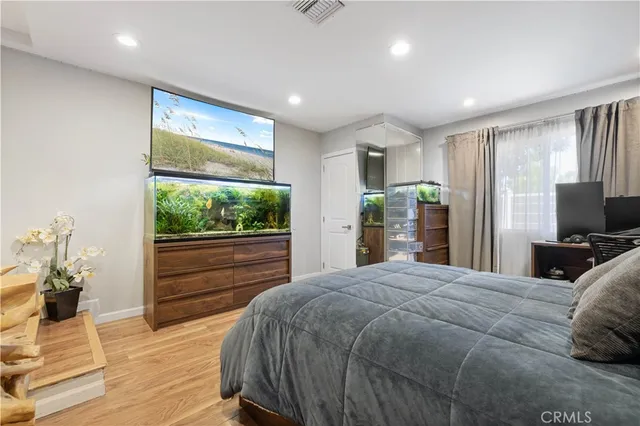 a bedroom with a bed and a large window