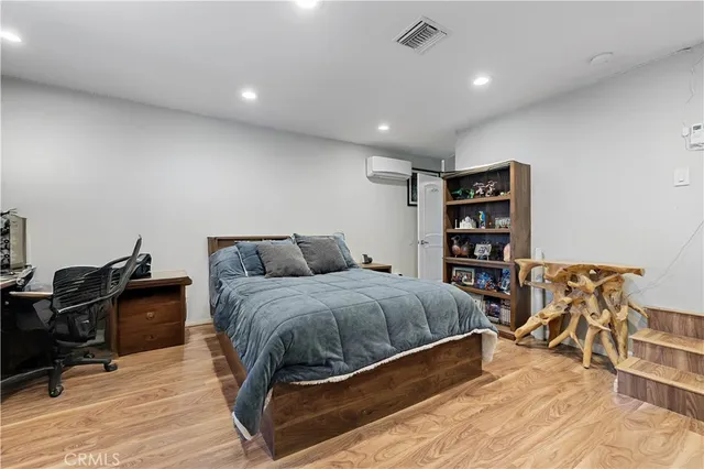 a bed room with a bed and a book shelf