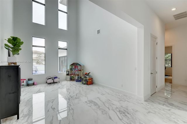 a view of a hallway with wooden floor and entryway