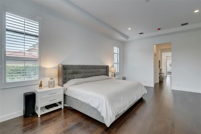 a bathroom with a granite countertop sink a mirror and shower