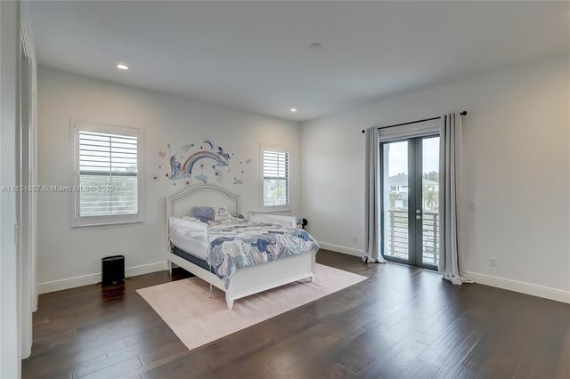 a view of a living room with furniture and wooden floor