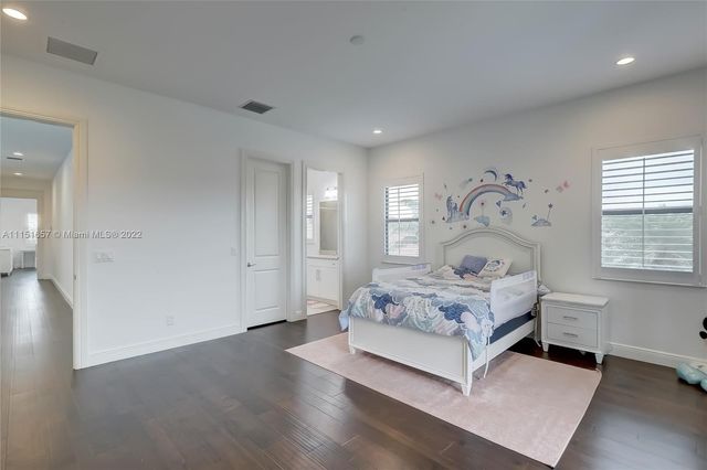 a view of a room with lots of wooden furniture