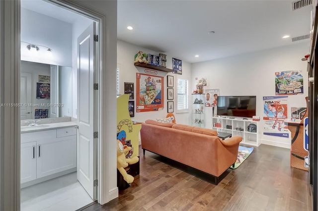 an aerial view of residential houses with outdoor space and trees