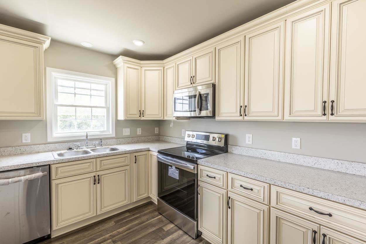 125 Rhodes Hill Drive Dayton, VA 22821 - Photo 17 of 37 a kitchen with stainless steel appliances granite countertop white cabinets a sink and dishwasher next to a window