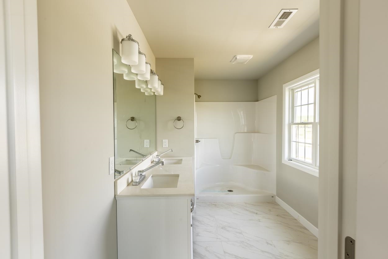 125 Rhodes Hill Drive Dayton, VA 22821 - Photo 26 of 37 a bathroom with a granite countertop mirror and a shower