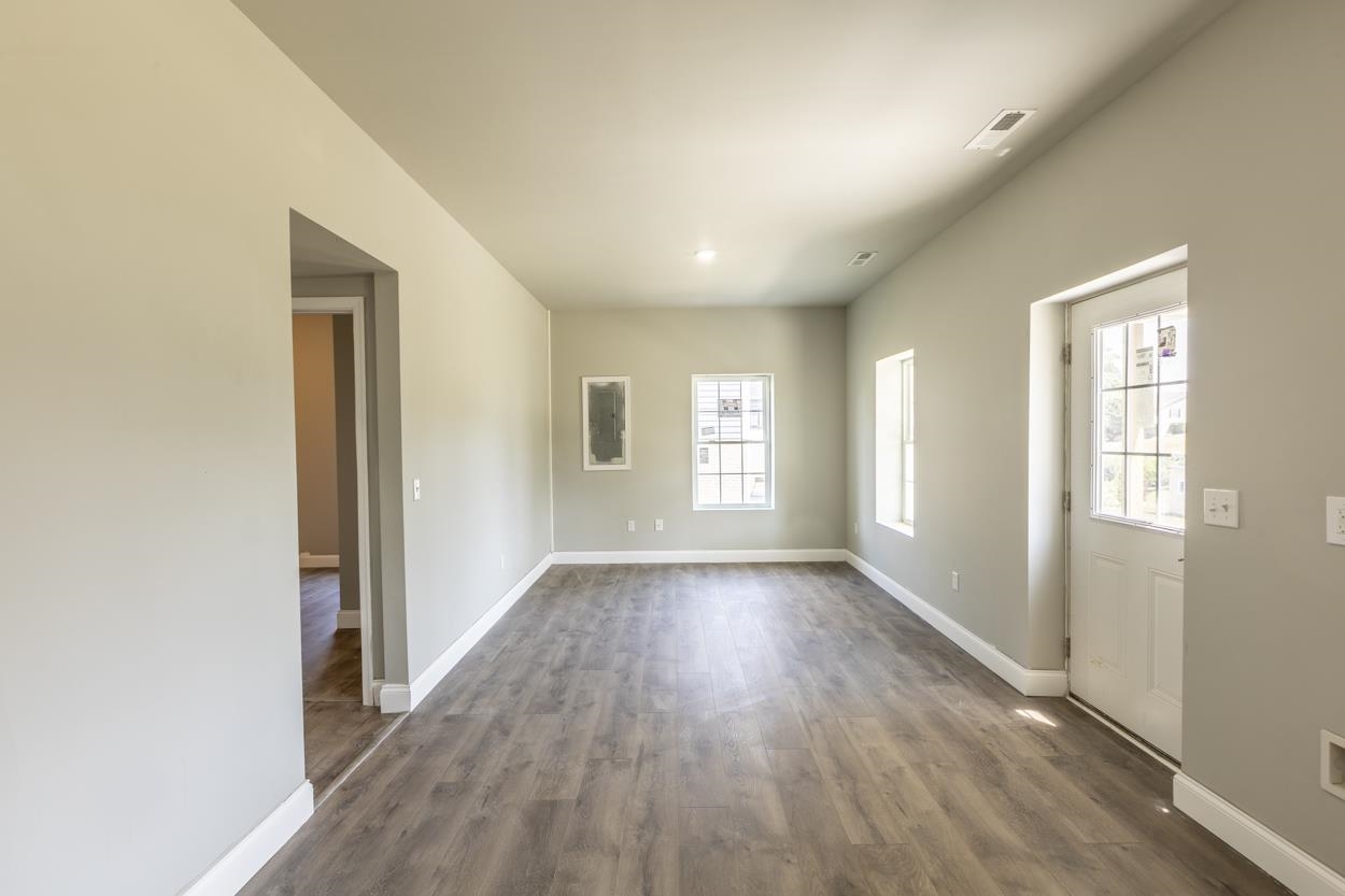 125 Rhodes Hill Drive Dayton, VA 22821 - Photo 32 of 37 an empty room with wooden floor and windows
