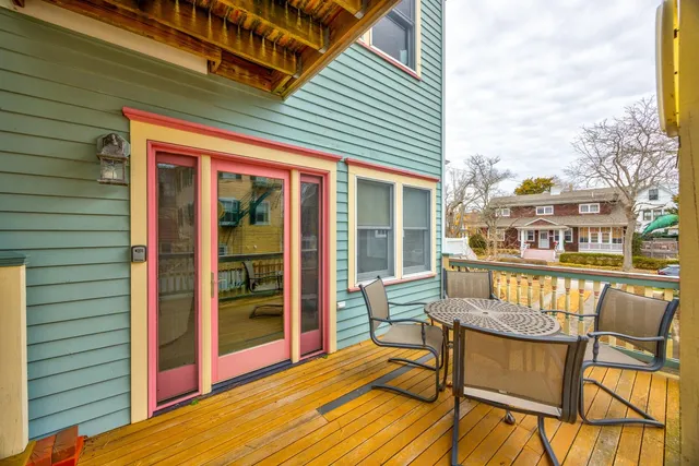 a balcony with furniture and wooden floor