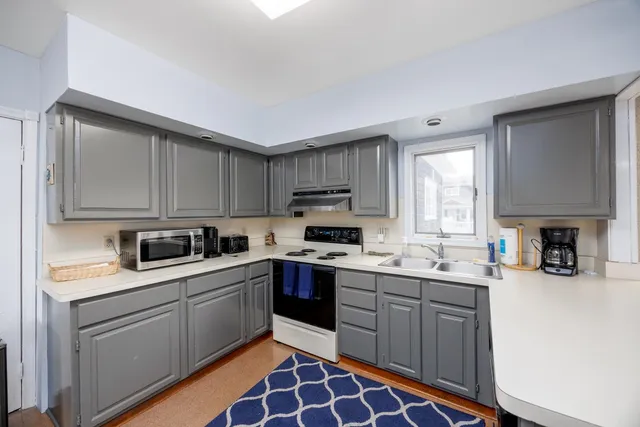 a kitchen with a sink stove and cabinets