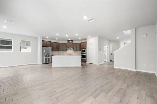 a kitchen with granite countertop cabinets stainless steel appliances and a counter space