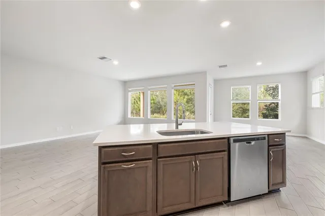 a view of a kitchen with a sink and a stove top oven