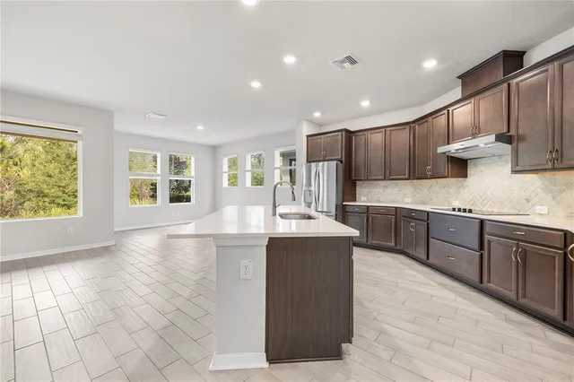 a view of a hallway with wooden floor and closet