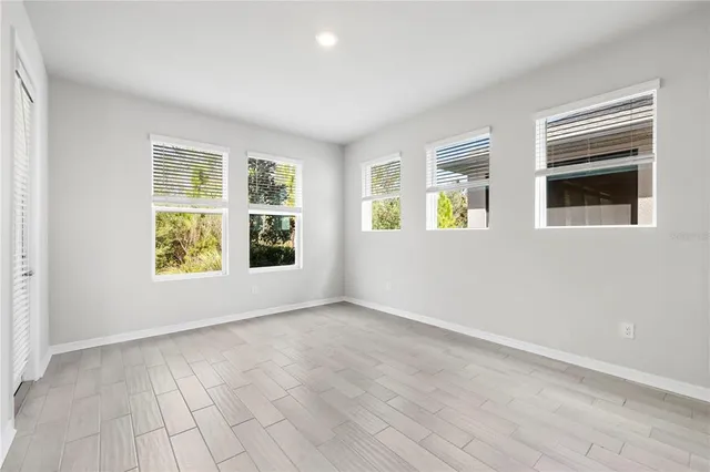 a view of an empty room with wooden floor