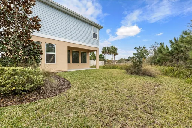 a spacious bathroom with a double vanity sink a mirror and a bathtub