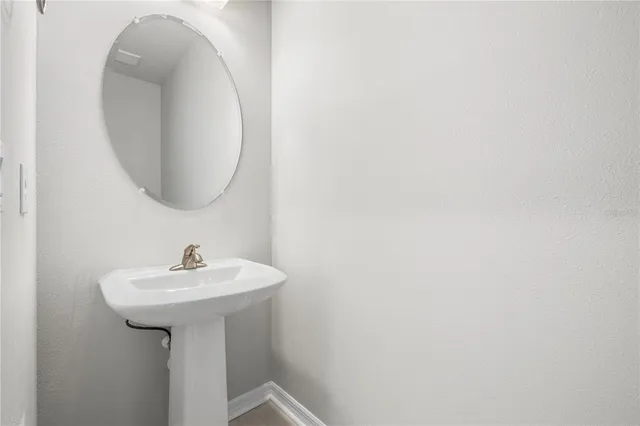 a large kitchen with stainless steel appliances a refrigerator a oven a sink and a stove