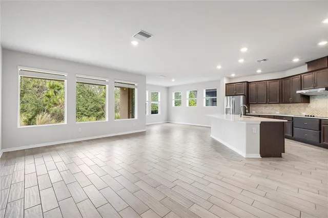 a kitchen with stainless steel appliances granite countertop a sink a stove and cabinets