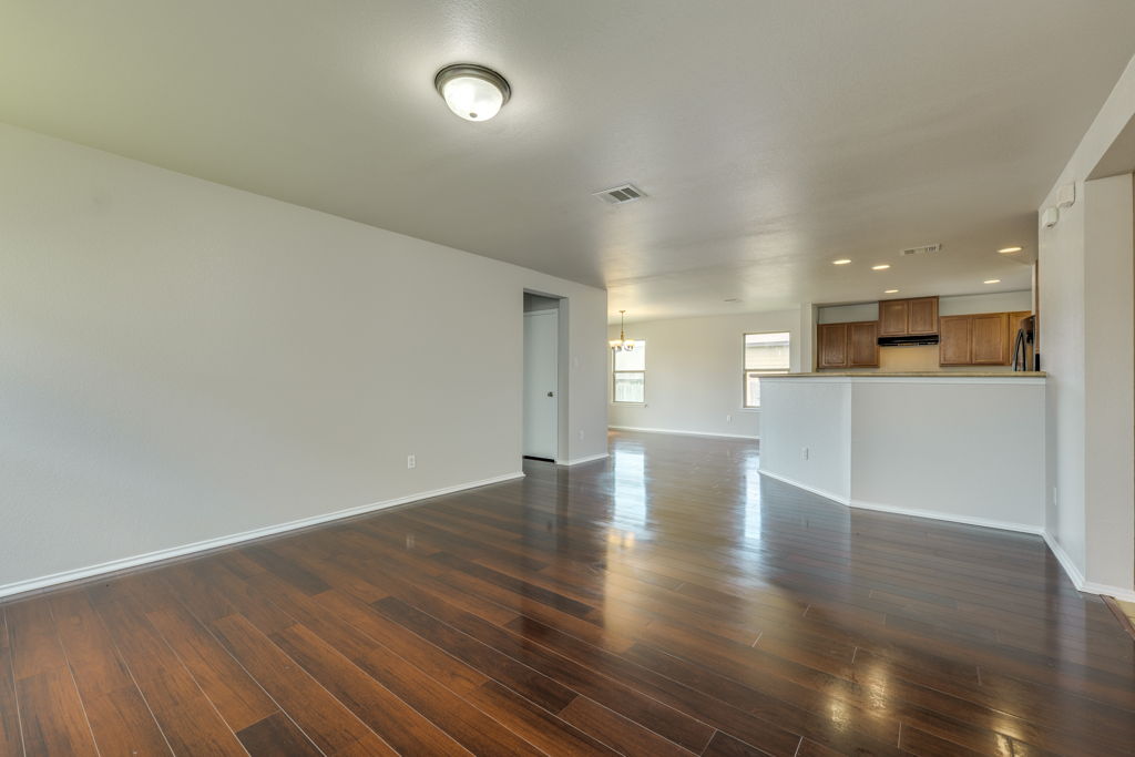 210 Cushman Drive Kyle, TX 78640 - Photo 5 of 21 Spacious room featuring wood-finish flooring, a neutral wall palette, and recessed lighting