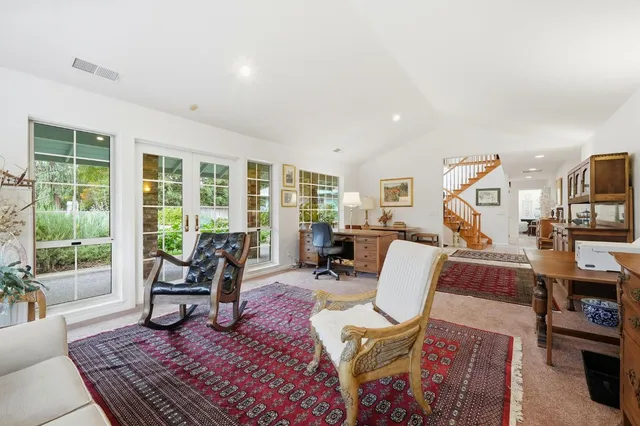 a view of a livingroom with stairs and furniture