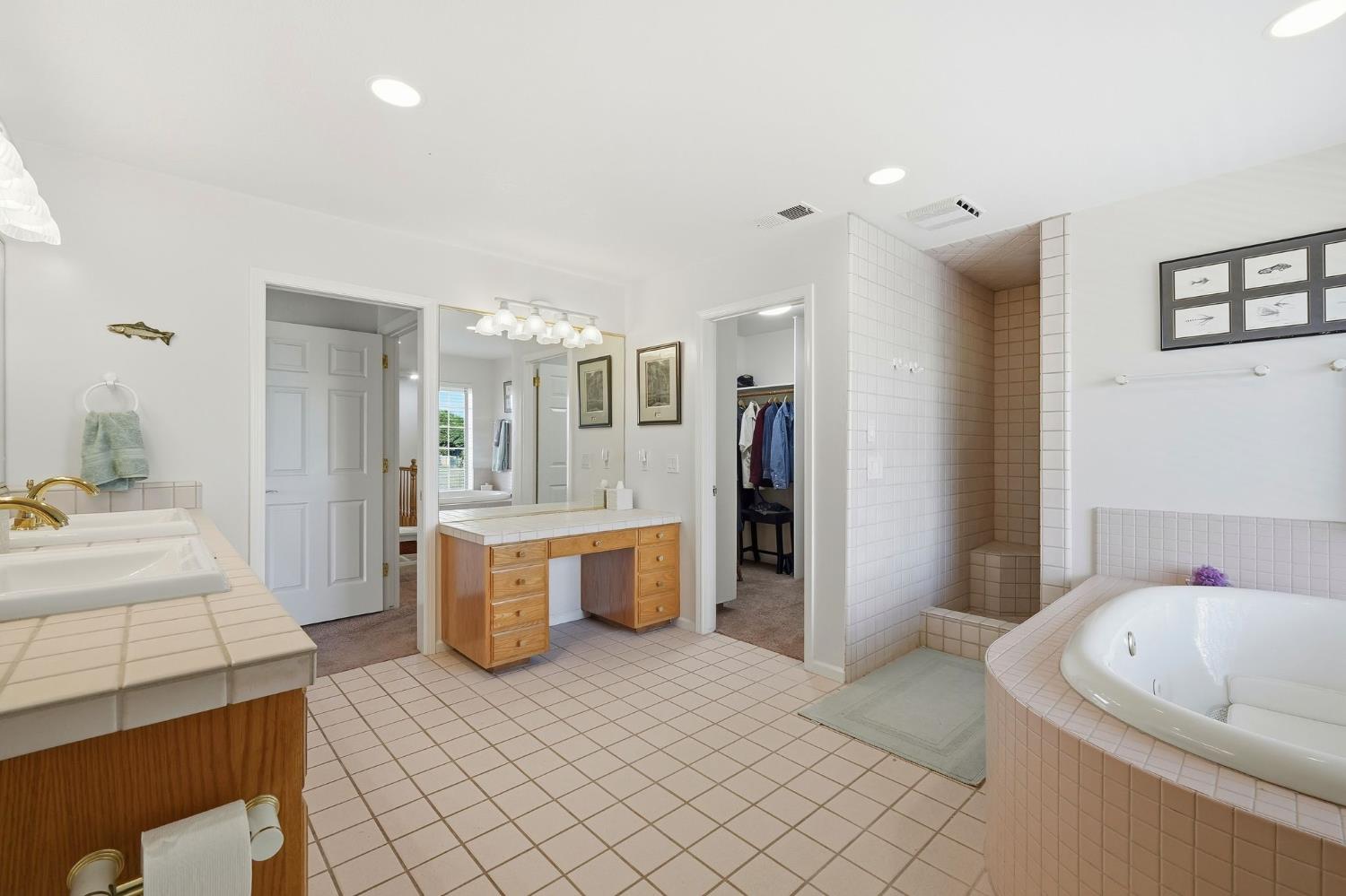 6380 Landmark Place Stockton, CA 95215 - Photo 15 of 39 a bathroom with a tub sink and mirror
