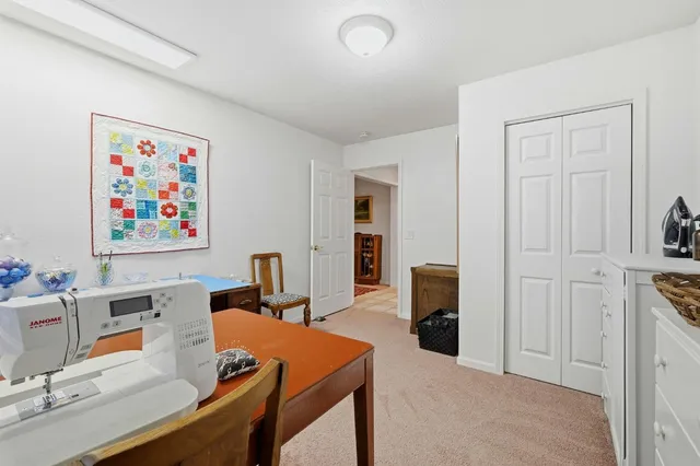 a view of a hallway with furniture and windows