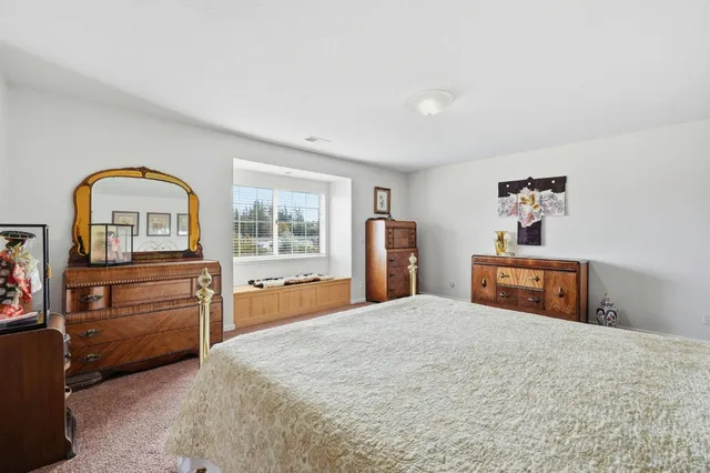 a spacious bathroom with a double vanity sink mirror and toilet