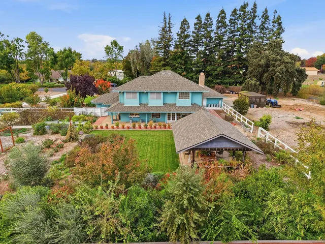 a view of a house with a yard and sitting area
