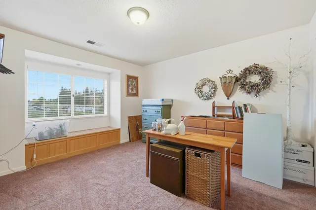 a bathroom with a granite countertop sink mirror and vanity