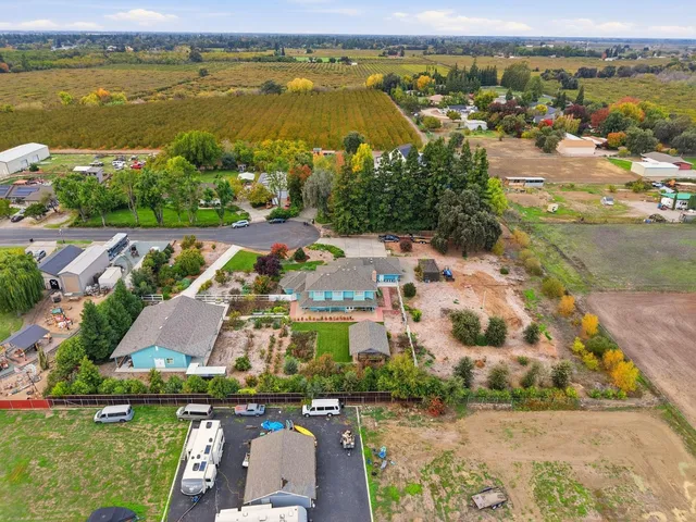 an aerial view of a house with a garden and trees