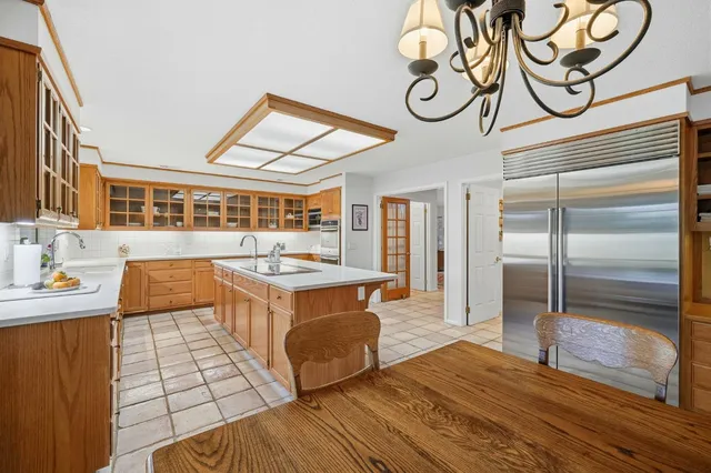 a kitchen with stainless steel appliances granite countertop a stove and a wooden floors