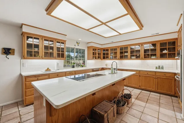 a view of a kitchen with a stove and large window