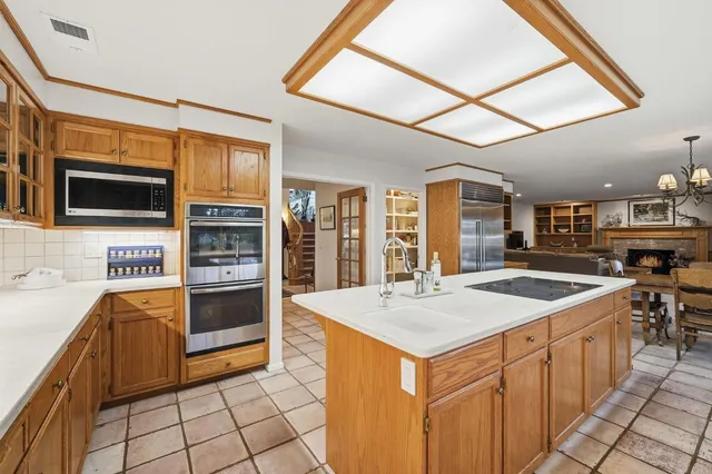 a kitchen with stainless steel appliances granite countertop a stove and a sink