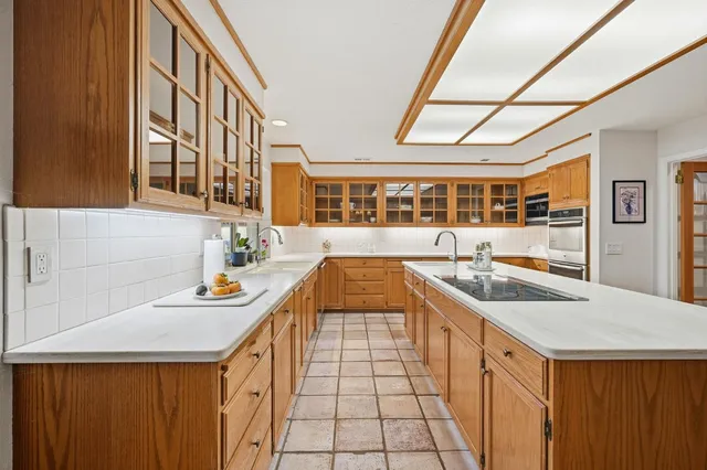 a kitchen with stainless steel appliances granite countertop a sink and a stove