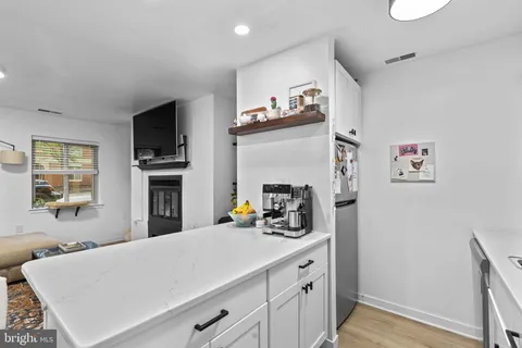 a kitchen with a refrigerator and a sink
