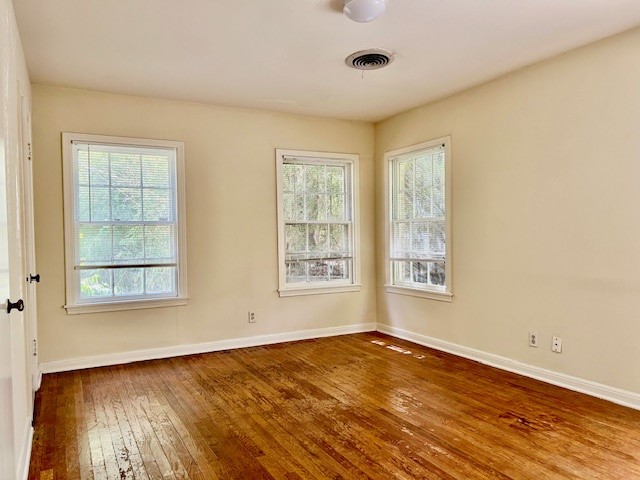 923 Keith Lane Austin, TX 78705 - Photo 13 of 21 a view of an empty room with wooden floor and a window