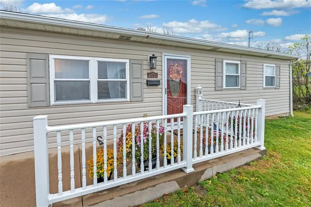 a living room with furniture ceiling fan and a window