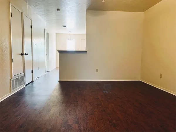 a view of a kitchen with wooden floor and a sink
