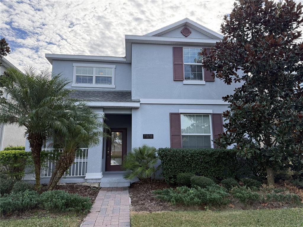 11818 Epic Avenue Orlando, FL 32832 - Photo 1 of 28 a front view of a house with garden