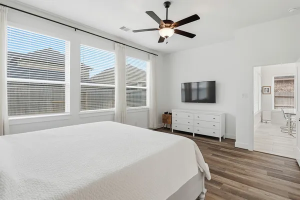 a bedroom with a large bed and a window