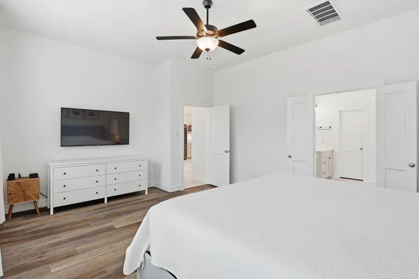 a bedroom with a bed and a chandelier