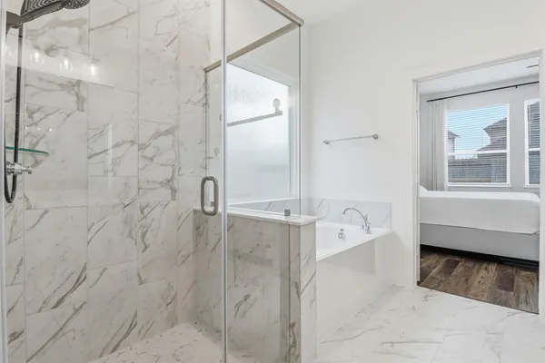 a bathroom with a bathtub and a shower