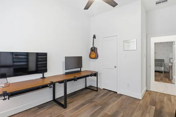 a view of a workspace with furniture and a window