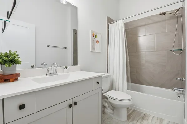 a spacious bathroom with a sink a vanity and a toilet
