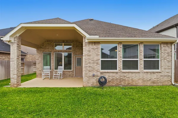 a view of a house with a yard and sitting area