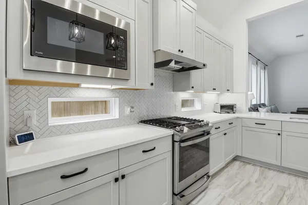 a kitchen with a sink cabinets and wooden floor