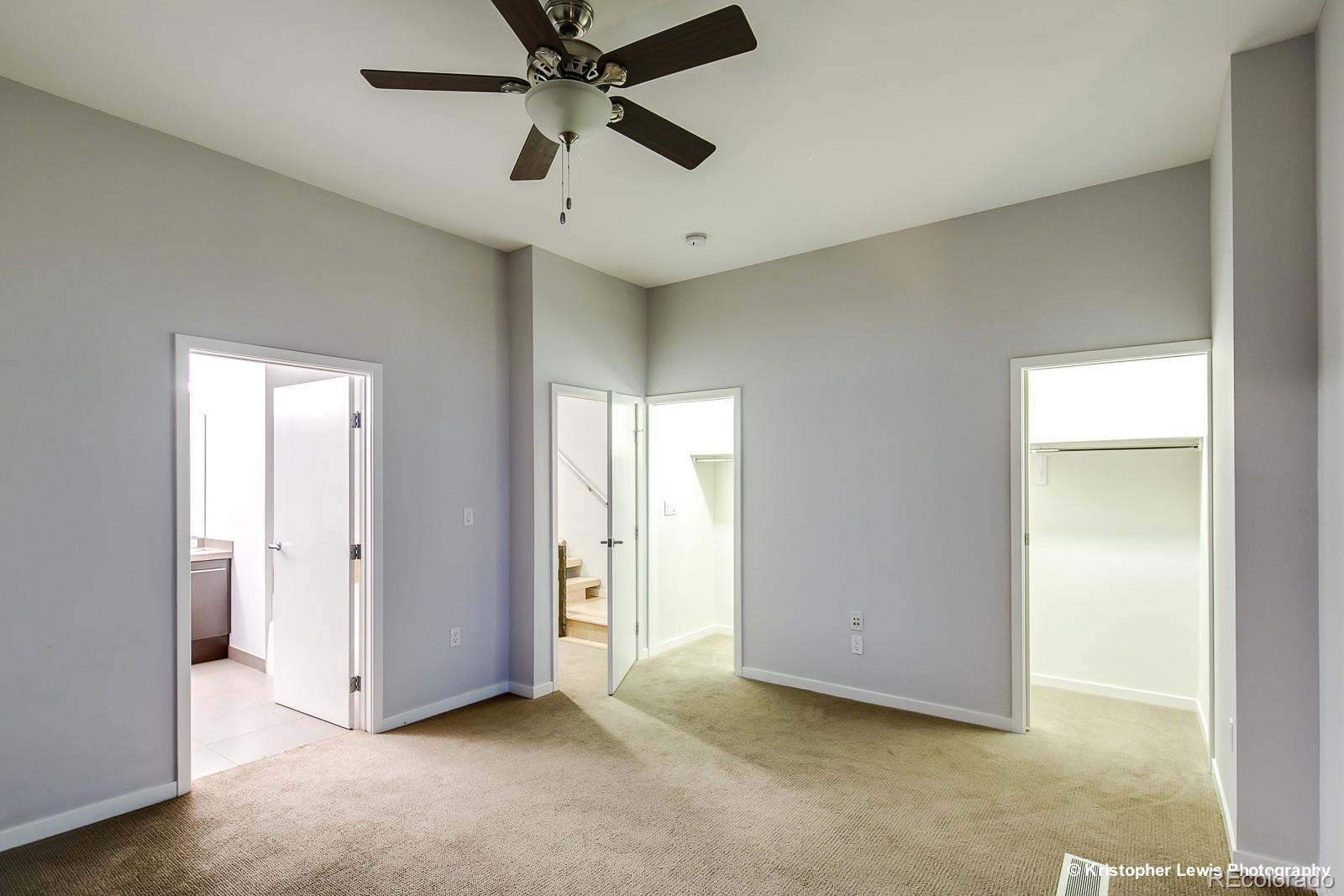 1400 Little Raven Street, Unit B Denver, CO 80202 - Photo 22 of 35 an empty room with a ceiling fan and closet area