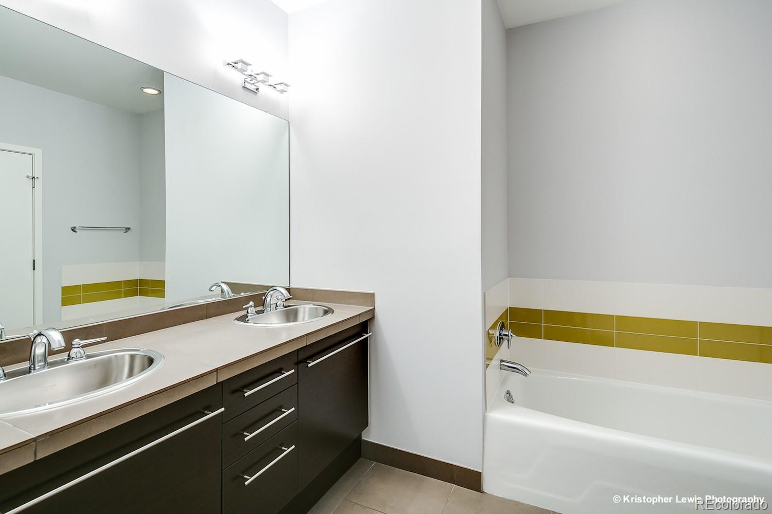 1400 Little Raven Street, Unit B Denver, CO 80202 - Photo 24 of 35 a bathroom with a tub sink and mirror