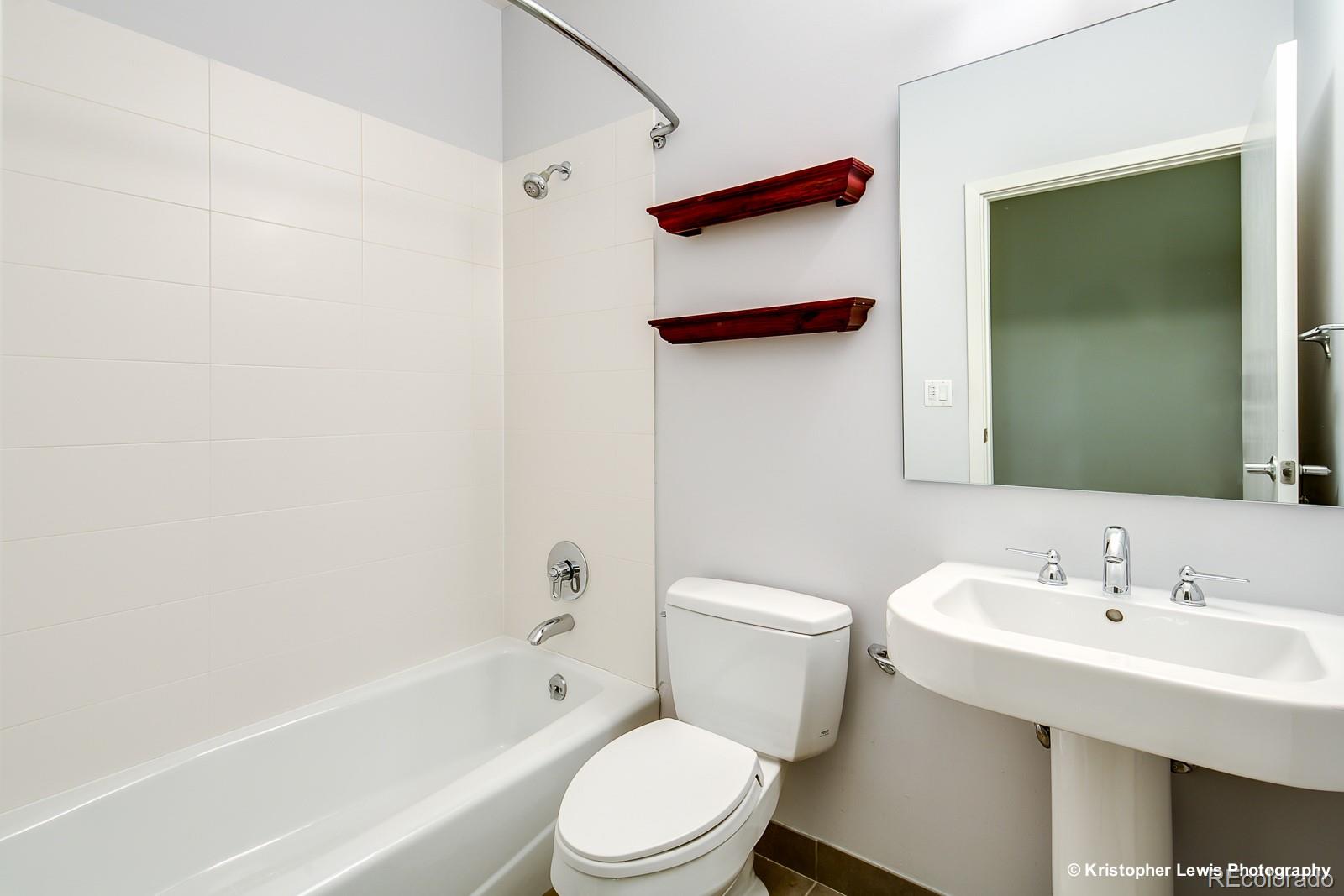 1400 Little Raven Street, Unit B Denver, CO 80202 - Photo 28 of 35 a white toilet sitting next to a bathroom sink