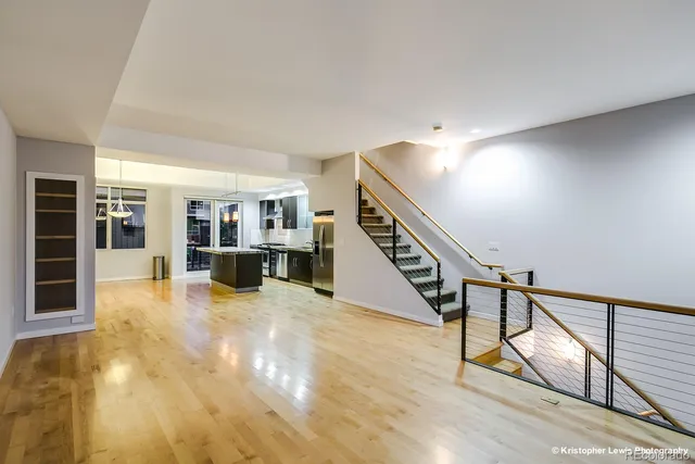 a large kitchen with a large counter top stainless steel appliances and cabinets