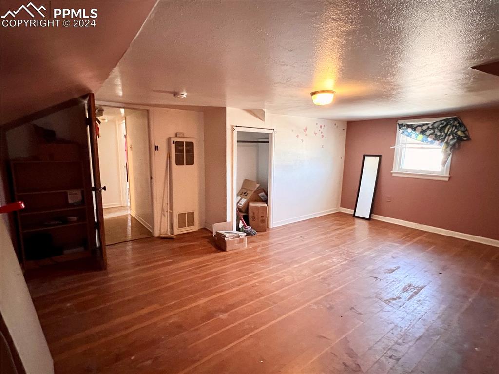 408 9th Street Fowler, CO 81039 - Photo 11 of 13 a view of a livingroom with wooden floor and a window