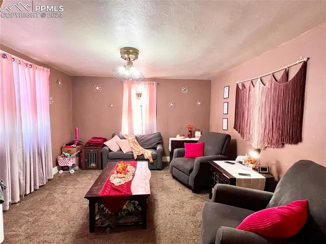 a living room with furniture and a chandelier