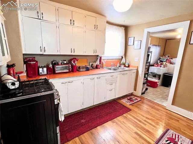 a kitchen with stainless steel appliances granite countertop a sink stove and cabinets